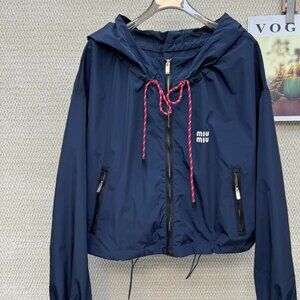 MIUMIU windbreaker, exquisitely tailored with a hood, combining workwear style w